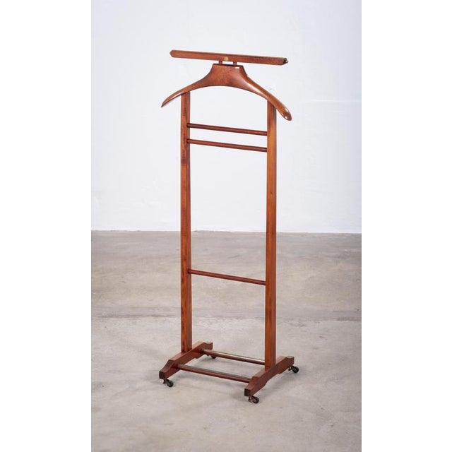 Elegant 1960s valet stand crafted in stained beech wood. Designed with a shaped hanger for jackets and a convenient pull-...