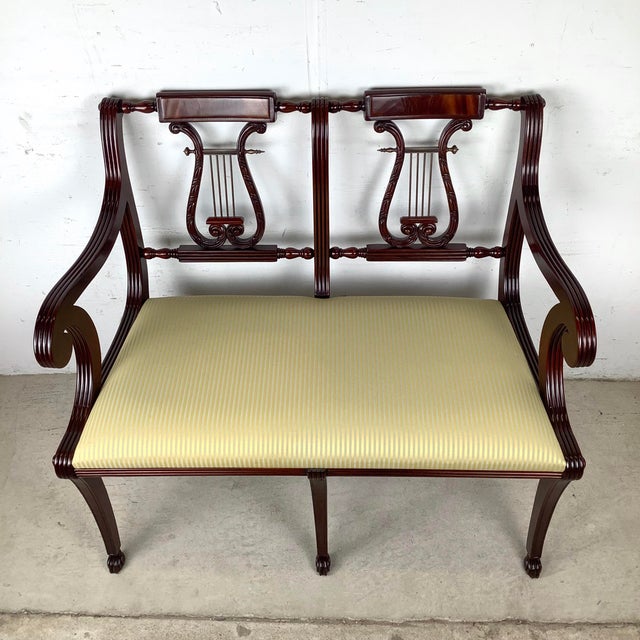 This refined lyre-back settee captures the elegance and balance of early American Federal design, interpreted through the...
