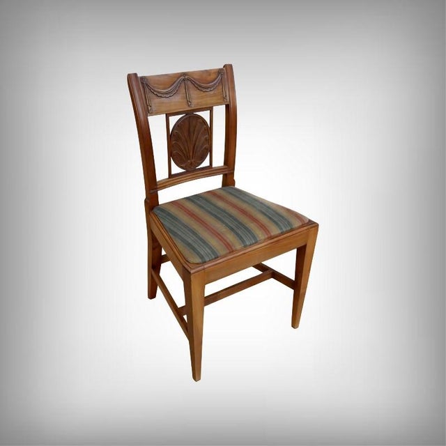 This set of twelve cherrywood chairs perfectly embodies the warm elegance of the Provençal style. Each chair has been...