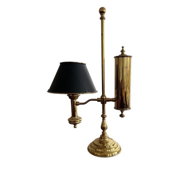 Vintage brass desk lamp with integrated pen holder in classic English banker style. Elegant and functional piece with...