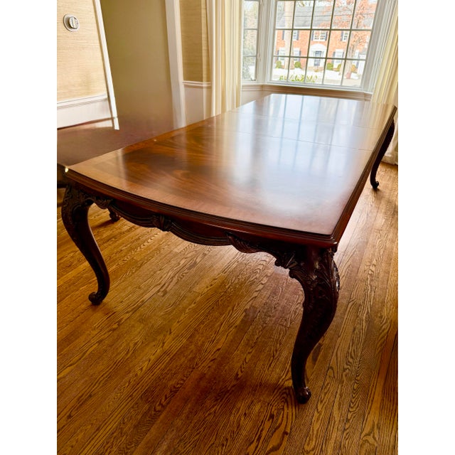 Mahogany wood table with hand carved details on legs and sides. Flame Mahogany Veneer: The central panels showcase a...