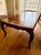 Mahogany wood table with hand carved details on legs and sides. Flame Mahogany Veneer: The central panels showcase a...
