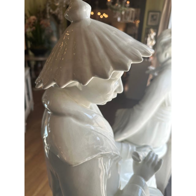 Exquisite pair of porcelain Oreintal figures seated on large embellished columns. Beautiful details, probably Italian,...