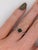 A green tourmaline takes centre stage in a fresh green at the centre of this solid 14K white gold ring, surrounded by six...