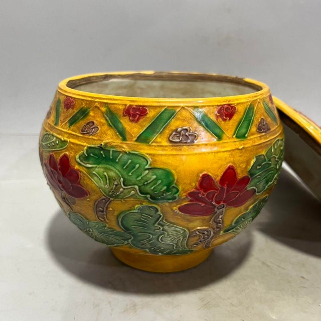 Vibrant Chinese lidded porcelain jar with a rich golden-yellow glazed base, decorated in raised relief polychrome enamels...