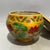 Vibrant Chinese lidded porcelain jar with a rich golden-yellow glazed base, decorated in raised relief polychrome enamels...