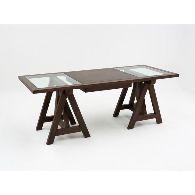 Oversized executive trestle desk featuring a rich dark-stained wood frame with distinctive A-frame trestle bases. The...