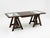 Oversized executive trestle desk featuring a rich dark-stained wood frame with distinctive A-frame trestle bases. The...