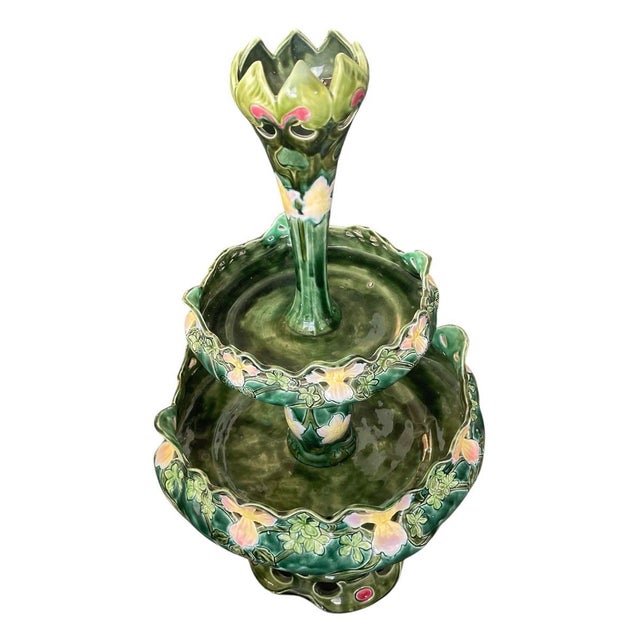 This striking turn-of-the-century tiered centerpiece exemplifying the fluid, organic elegance of the Art Nouveau period is...