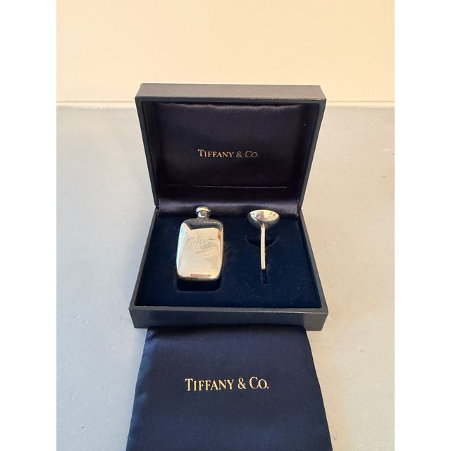Tiffany & Co. sterling silver perfume flask and funnel set with navy blue silk carrying bag and fitted presentation box...