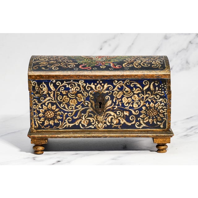 An exceptionally charming antique hand-painted wooden box, dating to the 19th century or earlier, this richly decorated...