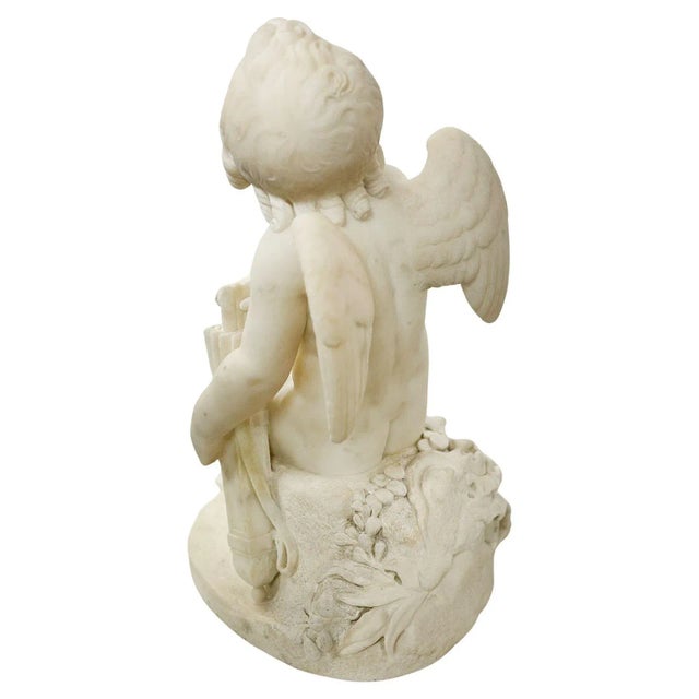 Adorable white marble carved sculpture of cupid made in Italy in the late 19th Century; he appears to have a set of arrows...