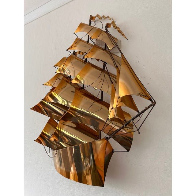 This piece is a vintage mid-century modern, hand-fabricated mixed-metal and brass sailing ship wall sculpture created by...