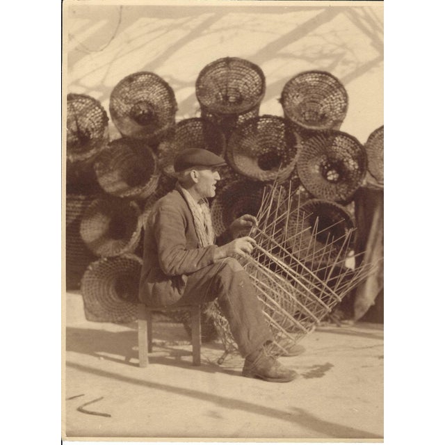 A sepia tone black and white photograph of a basket weaver in Europe, probably Italy or Greece. Unsigned, combined...