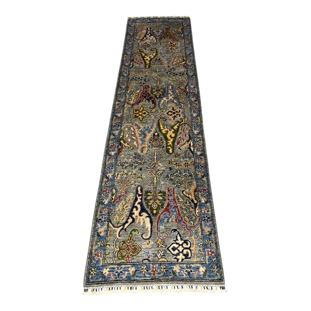 This Afghan Chobi natural-dye wool runner features a Persian Bijar-inspired floral design on a softly variegated gray...
