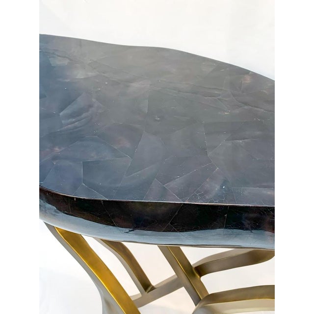 A contemporary french console table, acacia, by r & y augousti. This sculptural console table features a tessellated shell...
