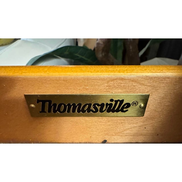 A beautifully crafted Thomasville Fredericksburg Collection mahogany credenza featuring an elegant marble top and classic...