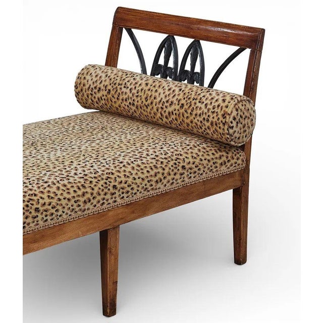 The Biedermeier Fruitwood and Ebonized Window Bench is a lovely antique piece of furniture that adds a touch of historical...