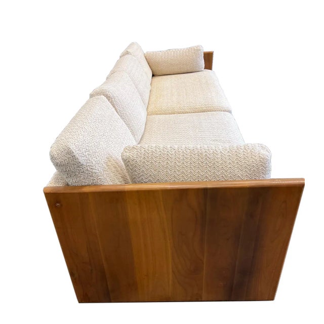 An absolutely fabulous mid-century sofa in the style of Milo Baughman. Unique wood-case design with gorgeous, walnut...