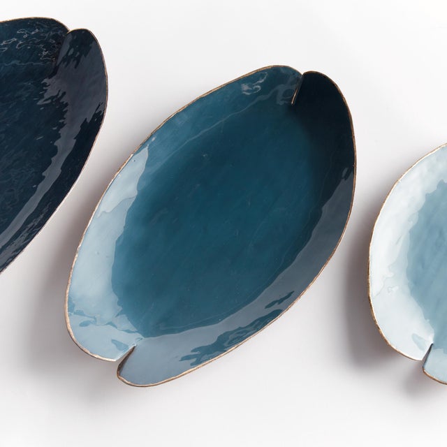 This charming set of handpainted decorative trays are inspired by lily pads. With aGold edge detail, and coordinating soft...