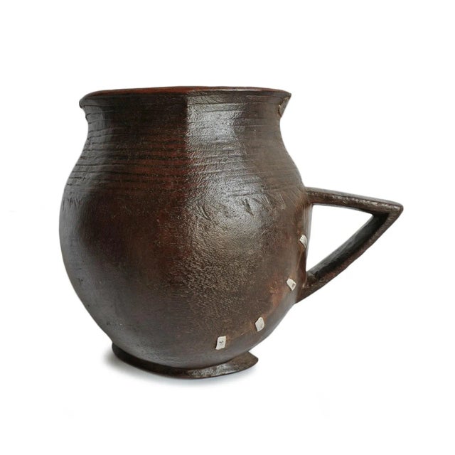 Vintage handmade village pitcher from North Africa. Rich dark wood with original aluminum repairs and traditional...
