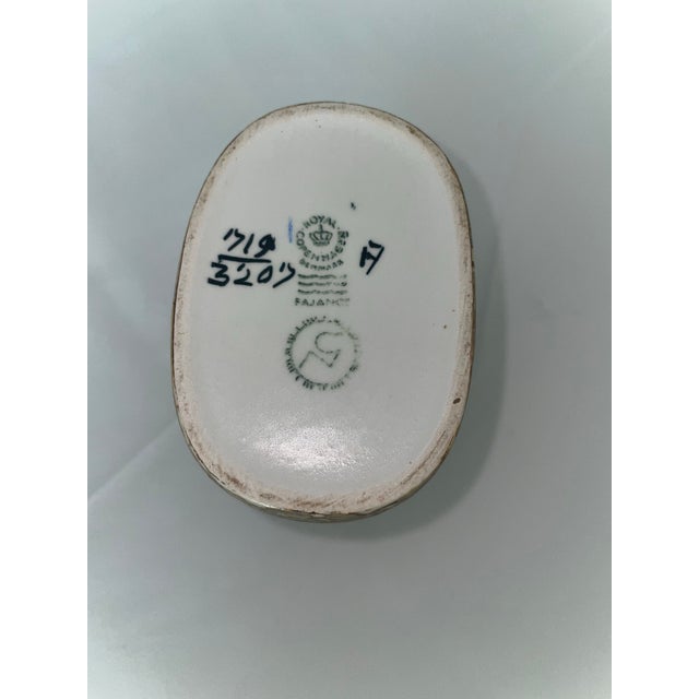 Royal Copenhagen Crown Mark with Three Waves: This is the primary factory mark, signifying that the piece was produced by...