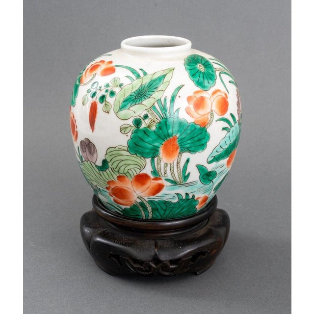 Chinese Famille Verte Glazed Porcelain Vase, hand-painted with lotus flower motif, together with carved wood stand. Vase:...