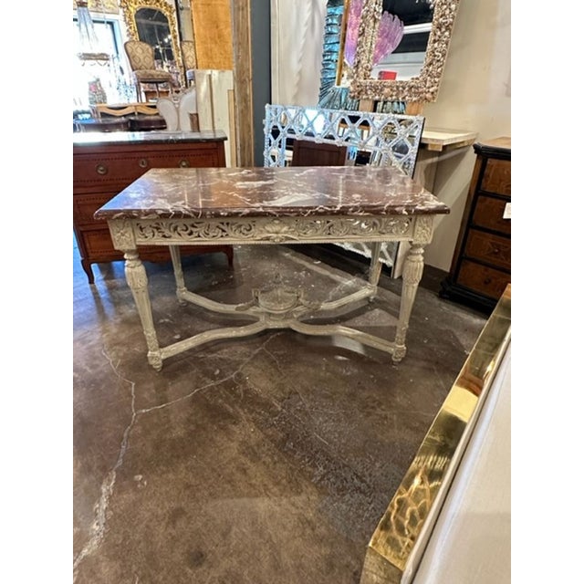 Lovely 19th century French Louis XVI carved and painted center table with original rouge marble top. Beautiful patina and...