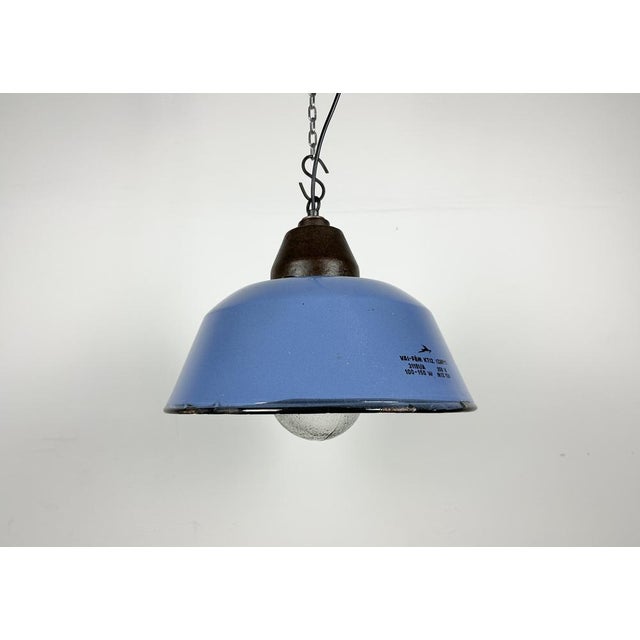 Industrial hanging lamp manufactured by Szarvasi Vas - Fém in Hungary during the 1960s. It features a blue enamel shade, a...