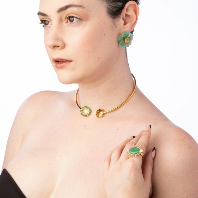 The Dania Studs, crafted from semi-precious stones, feature a distinctive flower design accentuated by a contrasting...