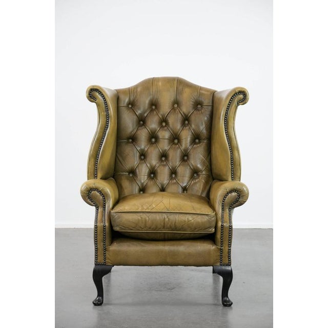 We are offering this moss green cowhide leather Chesterfield wing chair in English style, finished with decorative nails....