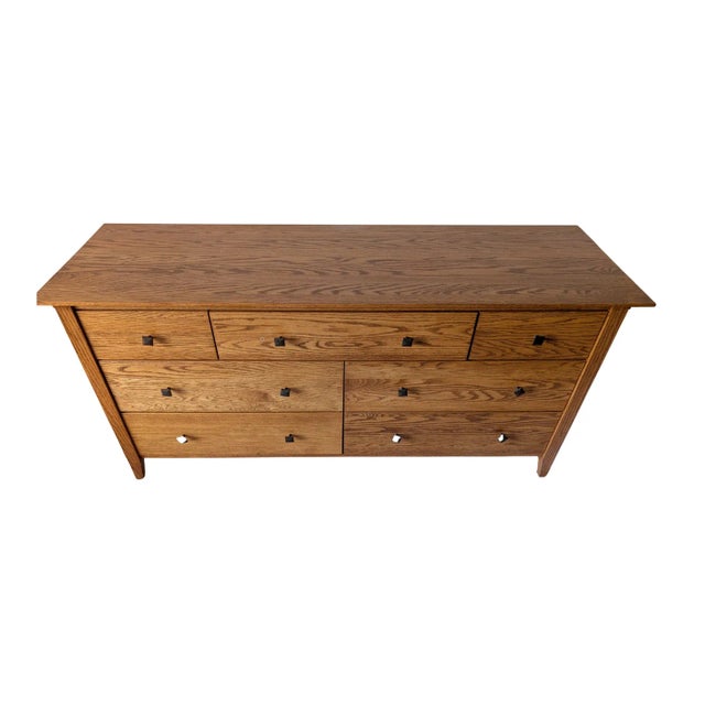 This custom-built solid American grown oak dresser showcases exceptional craftsmanship with a subtle Arts & Crafts...