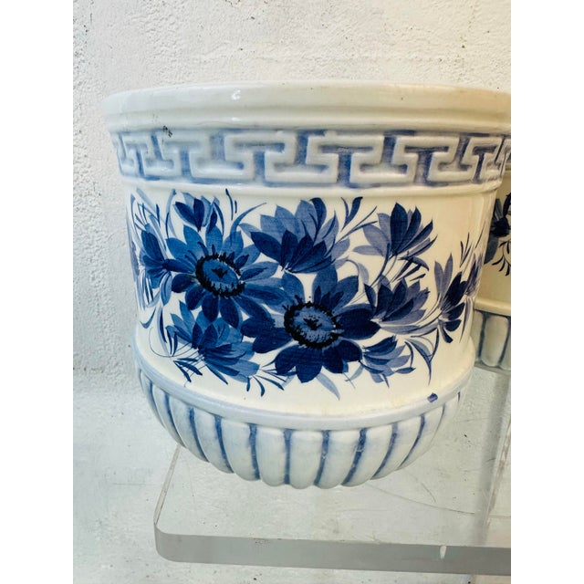 These are a charming pair of vintage ceramic cachepots (planters or decorative pots), featuring a classic blue-and-white...