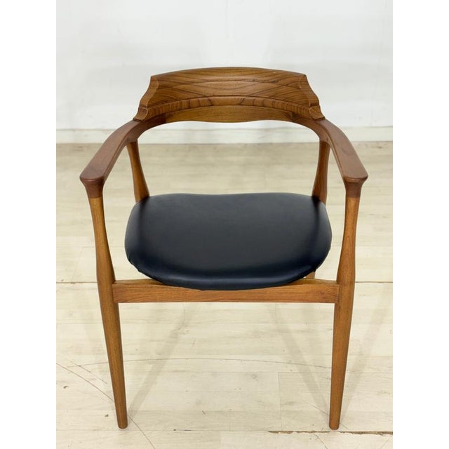 For sale is an elegant armchair in a trendy retro design, crafted from high-quality walnut with an easy-care black faux...