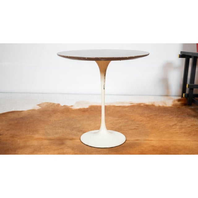 Eero Saarinen's Tulip side table for Knoll Associates, circa 1960s. White powder coated metal base supports a walnut...