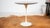 Eero Saarinen's Tulip side table for Knoll Associates, circa 1960s. White powder coated metal base supports a walnut...
