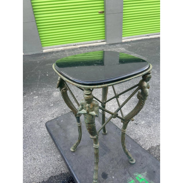 This is such an interesting verdigris metal Gueridon table. It features 4 praying mythological figures. It stands tall at...