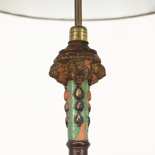 Unique wooden floor lamp, finished with turquoise paint. The old paint layer is visibly worn and weathered, giving it a...