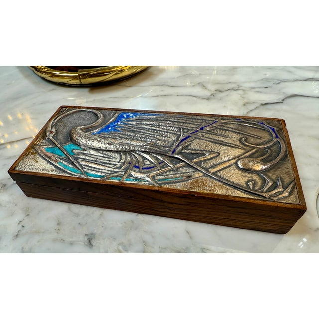 The Vintage Decorative Italian Wood Box from the 1980s is a charming and unique piece featuring a silver metal decoration...