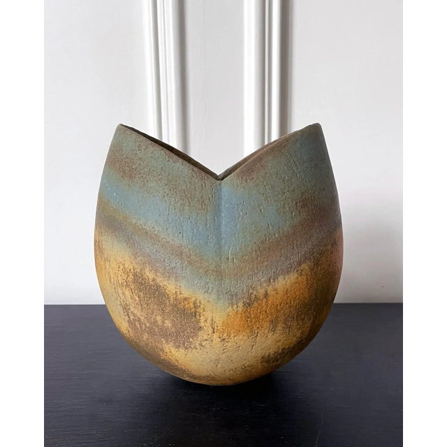 A stoneware vessel with glazed and banded stripes design by British studio ceramist John Ward (1938-) circa 1980s. The...
