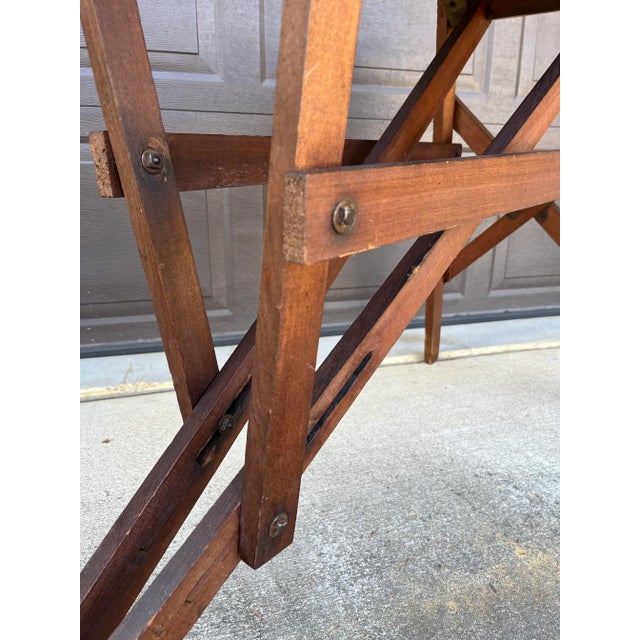 Unique structural piece! This folding antique ironing has all the character with adjustable slides and unique construction.