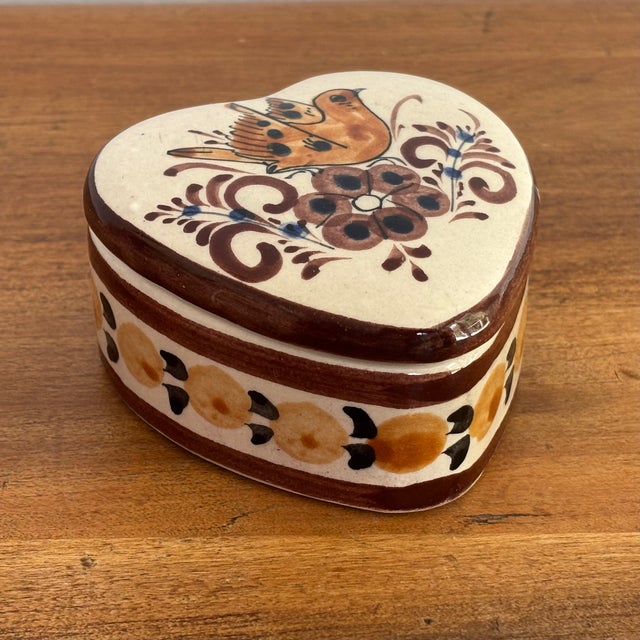 Beautiful heart shaped Tonalá box, handcrafted from bruñido clay and hand painted with earth-toned bird, flower and...