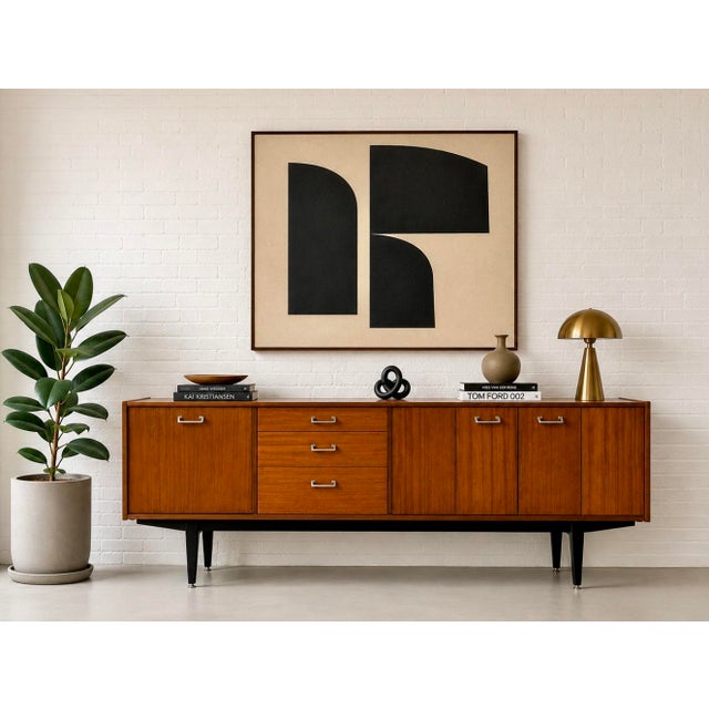 Mid Century Modern sideboard by Nathan Furniture of England, featuring a beautifully streamlined profile, warm wood tones,...