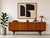 Mid Century Modern sideboard by Nathan Furniture of England, featuring a beautifully streamlined profile, warm wood tones,...