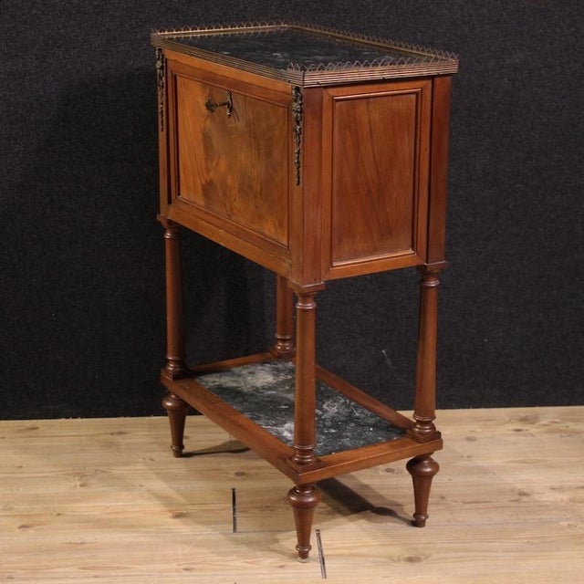 Small French secretaire from the mid-20th century. Empire-style cabinet carved and veneered in mahogany, and fruitwood....