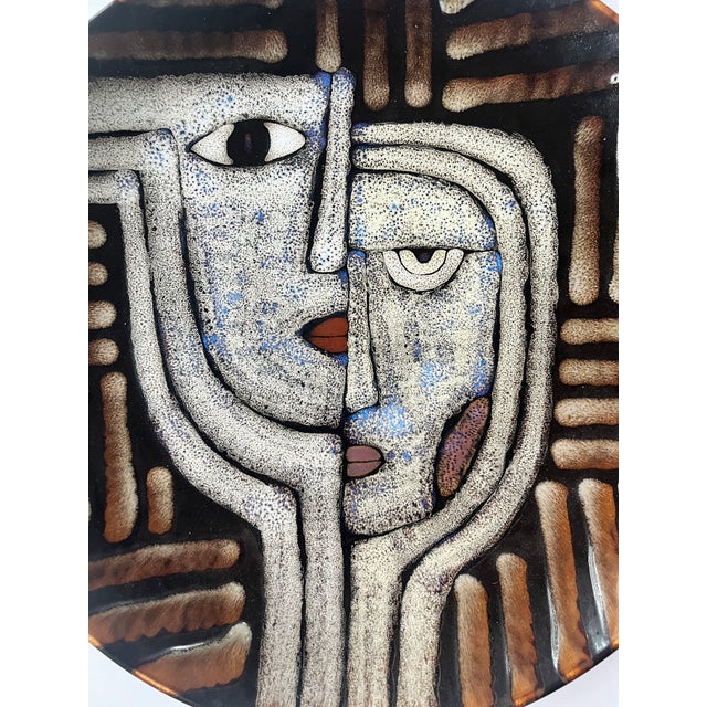 Decorative Porcelain Art Glass Bowl with 2 Faces, brown with drip glaze. This piece can be hung on the wall or used as a...