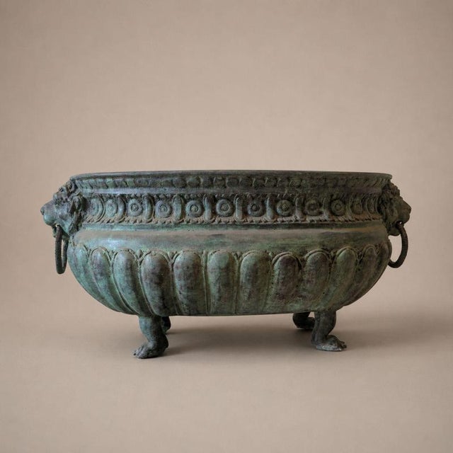 An important monumental oval planter from the early 1900s, crafted from lost-wax cast bronze and featuring a refined...