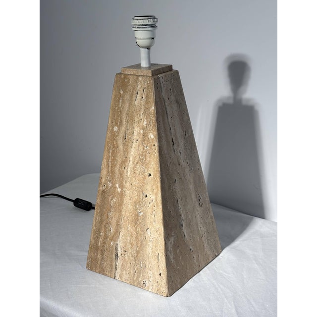 A remarkable pyramidal lamp base with a square cross-section, carved from a single block of unbound Roman travertine with...
