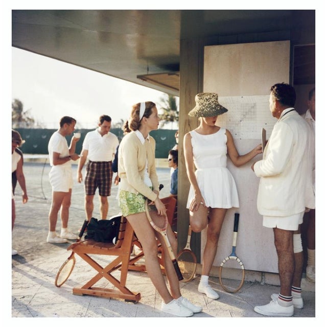 Tennis In The Bahamas 1957 Two women stand talking to a man on the edge of a tennis court in the Bahamas, circa 1957....