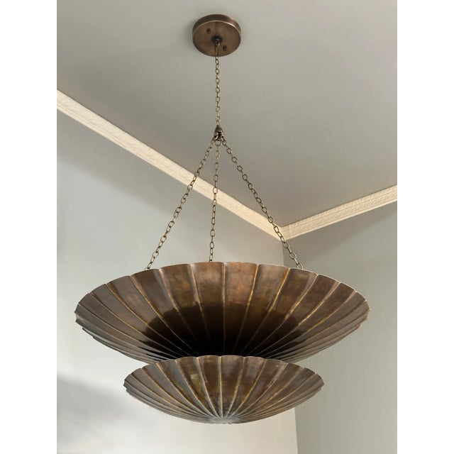 Elevate your space with this stunning vintage brass chandelier, designed in a sculptural two-tier shell form. With its...